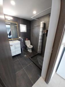 a bathroom with a toilet and a sink at SOUVLIA BEACH in Parasporos