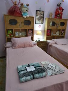 a bedroom with two beds with items on it at 2 bedroom, 4 beds, apartment in El sheikh Zayed Cairo Egypt in Sheikh Zayed