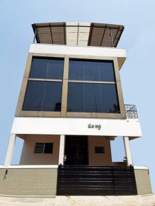 a tall building with a lot of windows at OM SHAKTI in Belgaum