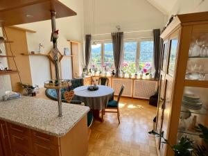 a kitchen with a table in the middle of a room at Ferienwohnung Martens Villa in Bad Aussee