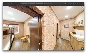 a bathroom with a brick wall and a sink at Hostel Pirosmani in Tbilisi City