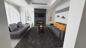 a living room with a couch and a fireplace at Villetta Elma in Menfi