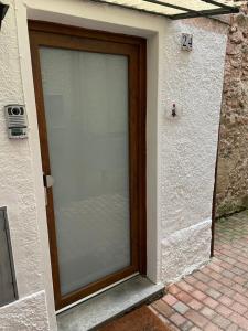 a sliding glass door of a building with the number at Cà Rosina Casavacanze in Brusimpiano