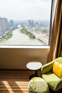 a room with a view of a river from a window at Four Points By Sheraton Guilin Lingui in Guilin