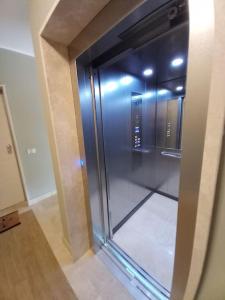una puerta de cristal de un ascensor en un edificio en Luxury home near the Beach private parking space, en Alghero