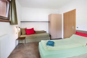 a small room with two beds and a couch at Mele Baitel li Pigna in Livigno