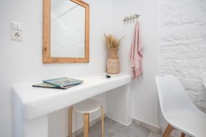 a bathroom with a white sink and a mirror at Zas Studios in Naxos Chora
