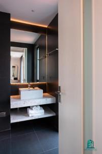 a bathroom with a white sink and a mirror at Luxe Paradise Residence 5 Tu Hoa in Hanoi