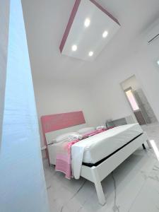 a bedroom with a bed in a white room at Raf's House in Olbia +22 photos