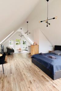a bedroom with a bed and a living room at Der Stader Hafenblick in Stade