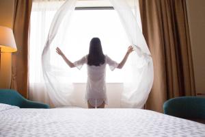 a woman is standing in front of a window at Four Points By Sheraton Guilin Lingui in Guilin