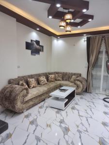 a living room with a couch and a table at Coral House in Hurghada