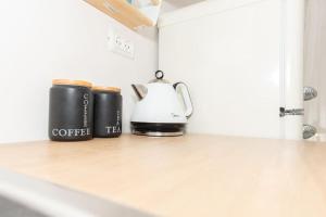 a coffee maker and a tea kettle on a kitchen counter at Cosy and Suits apartment in Jerusalem