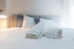 a white towel laying on top of a bed at Cosy and Suits apartment in Jerusalem