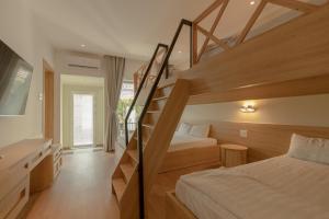 a bedroom with a bunk bed and a staircase at Tây Tiến Bungalow in Phú Quốc +36 photos