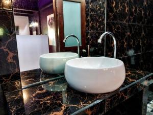 a bathroom with a sink and two faucets on a counter at Wirason Residence in Lamai