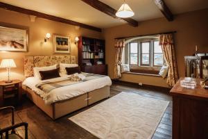 a bedroom with a large bed and a window at Large Country Farmhouse in Waddington