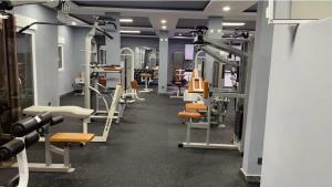 a gym with a row of treadmills and machines at Dal Ak jamm in Guediawaye