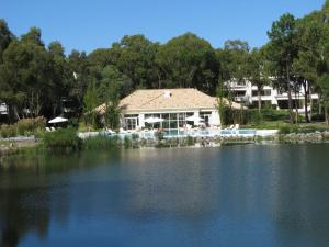 a house sitting next to a large body of water at Green Park en Punta del Este in Punta del Este