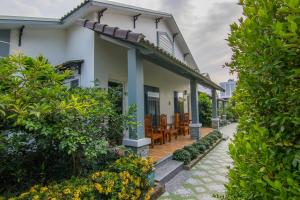 a house with a porch with chairs and plants at Tây Tiến Bungalow in Phú Quốc