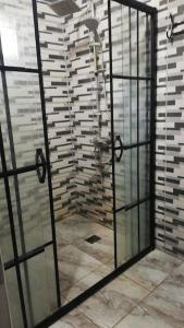 a shower with a glass door in a bathroom at göl manzarali ılıcaya ve göle 200m uzaklikta in Boyalıca