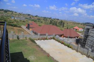 an overhead view of a building with red roof at The Junction Apartments in Mbarara