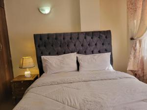 Postel nebo postele na pokoji v ubytování Cozy Apartment
