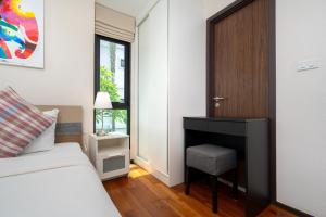 a bedroom with a bed and a chair and a door at New Apartment TTL B209 in New Rawai Beach Residence with Tropical Pools in Rawai Beach +14 photos