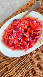 a bowl of red cabbage and onions on a table at BeSwahilid B & B in Bagamoyo