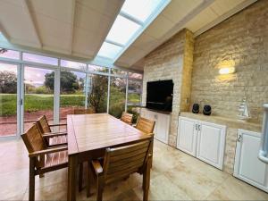 a kitchen and dining room with a table and chairs at Pinnacle Point Golf Estate - Golf Lodge 114 in Mossel Bay