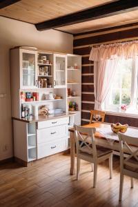 a kitchen with a table and a dining room at Chata Fajfrtka in Janov nad Nisou
