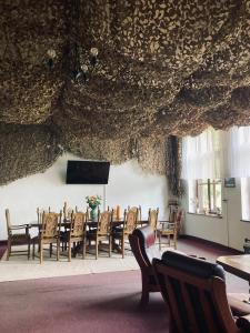 a dining room with a table and chairs at Stara Szkoła in Krempna