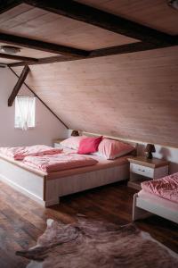 a bedroom with two beds in a attic at Chata Fajfrtka in Janov nad Nisou