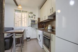 a small kitchen with a table and a stove at Charming Madrid Ferrocarril - Estancias Temporales in Madrid