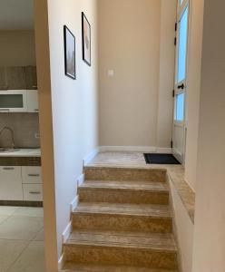 a stairway leading to a kitchen with a stair case at Apartman Vukoja in Grude