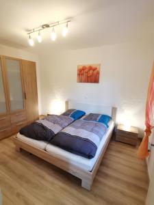 a bedroom with a large bed in a room at 4 Sterne Ferienwohnung Stammzeit in Nettersheim