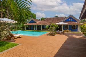 a villa with a swimming pool and a house at amã Stays & Trails Palmeira de Saligao, Goa in Old Goa