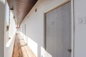 a hallway of a building with a wooden door at FabHotel Siddhi in Varanasi