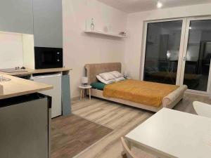 a small room with a bed and a kitchen at Waterfront City River view in Budapest