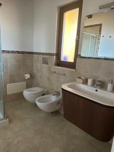 a bathroom with a sink and a toilet and a mirror at Le terrazze di Rosa in Polignano a Mare +35 photos