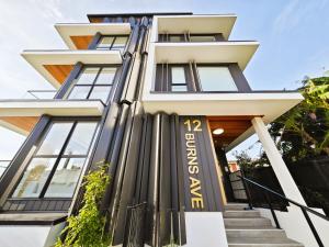 a building with a sign on the side of it at Takapuna Brand new 3 Bedrooms in Auckland