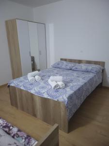 a bedroom with a bed with a mirror on it at Apartmani Škorpion in Kaštela
