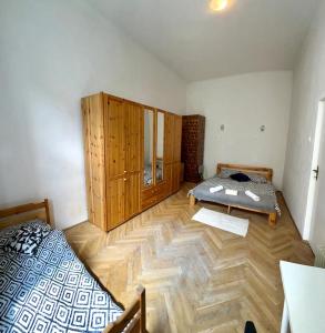 a bedroom with a bed and a wooden floor at Nice bedroom near the bus and train station in Krakow