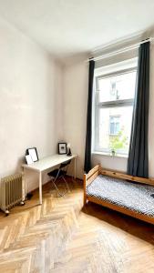 a room with a desk and a bed and a window at Nice bedroom near the bus and train station in Krakow