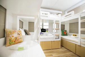 a bedroom with a white bed and a bathroom at Comfort Guest House in Hong Kong