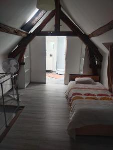 a bedroom with a bed in a attic at Bord de Loire in Gien