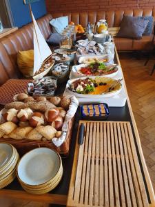 a long table with many plates and food on it at Hafen 17 Hotel Küche Bar in Kehl am Rhein