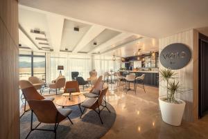 a room with chairs and tables and a kitchen at Valamar Tirena Hotel in Dubrovnik