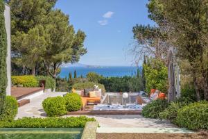 a garden with a view of the ocean at Villa Verde Costa Brava - BY EMERALD STAY in Begur