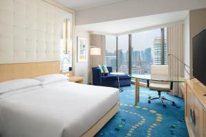 a hotel room with a bed and a desk at Renaissance Shanghai Yu Garden Hotel in Shanghai